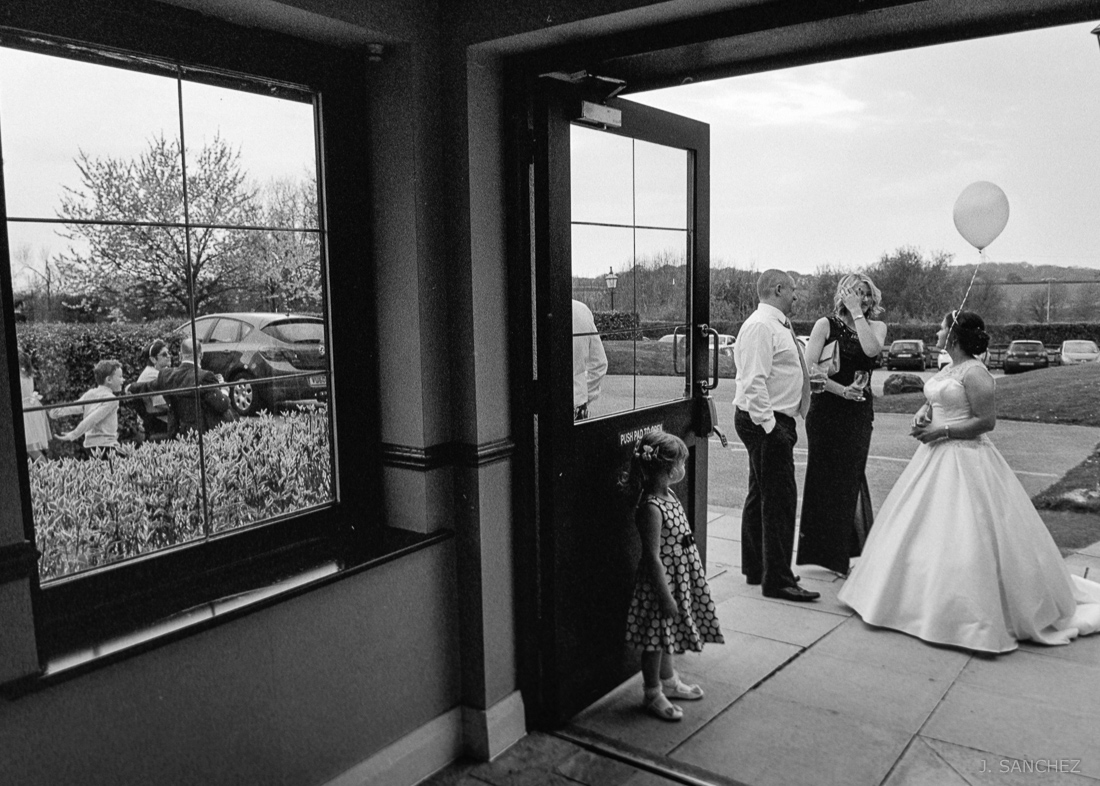 Bride and groom chatting with family and friends. Film wedding.